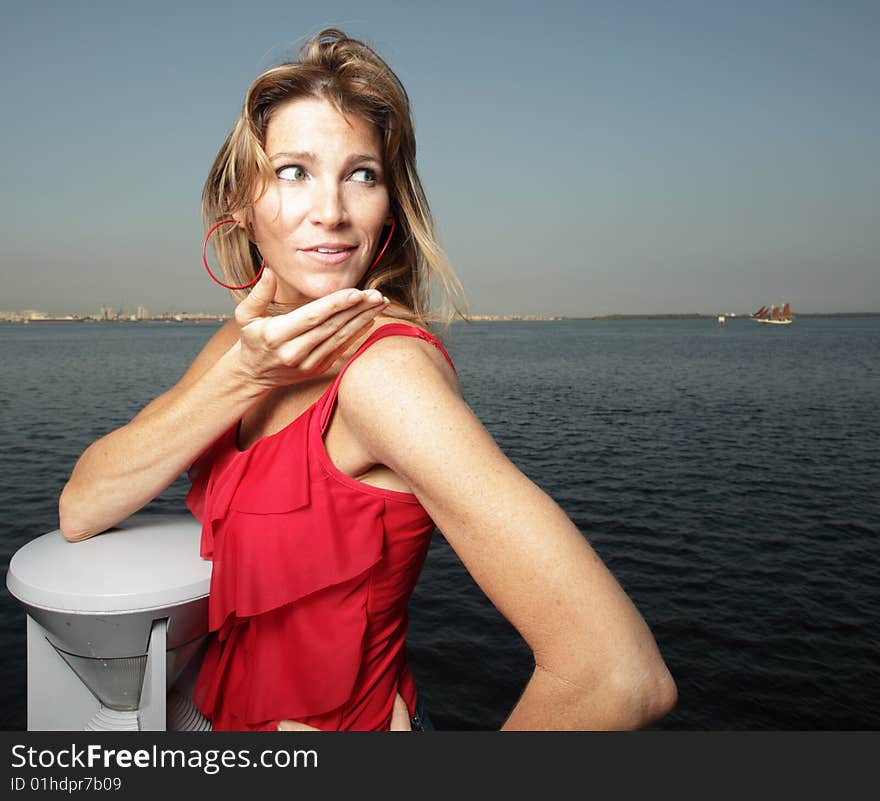 Woman wearing a red shirt with a blue horizon in the background. Woman wearing a red shirt with a blue horizon in the background