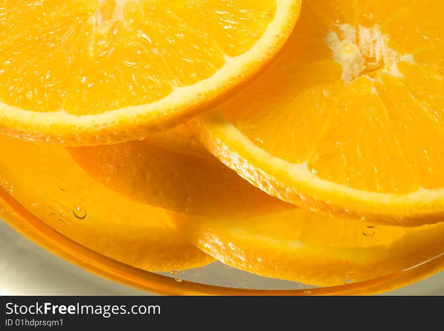 Bright orange slices on a reflecting surface