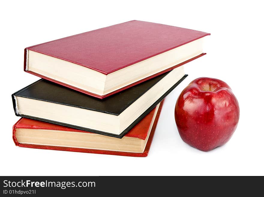 Red apple and books isolated on white. Red apple and books isolated on white