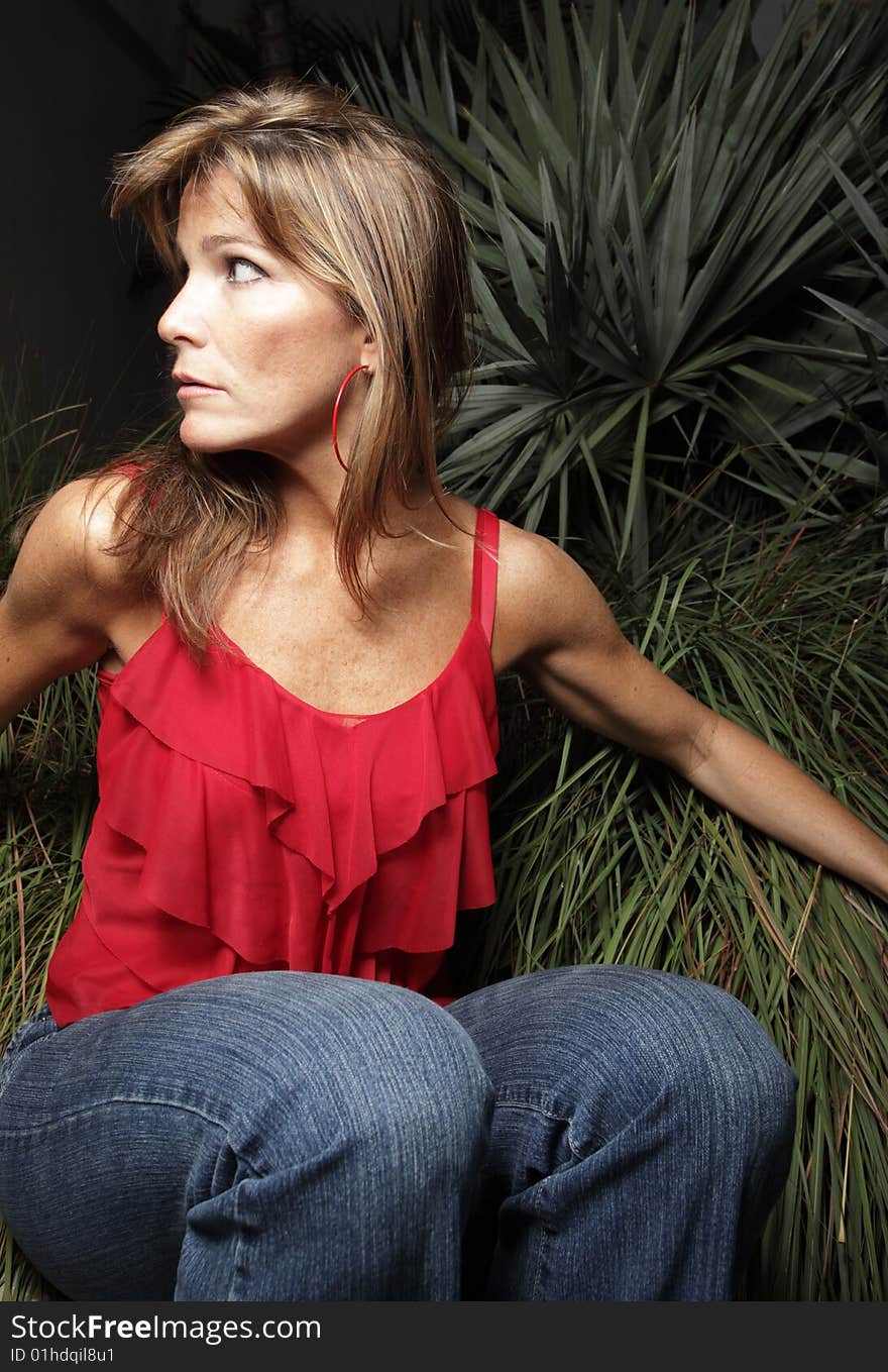 Woman sitting in a  nature scene. Woman sitting in a  nature scene