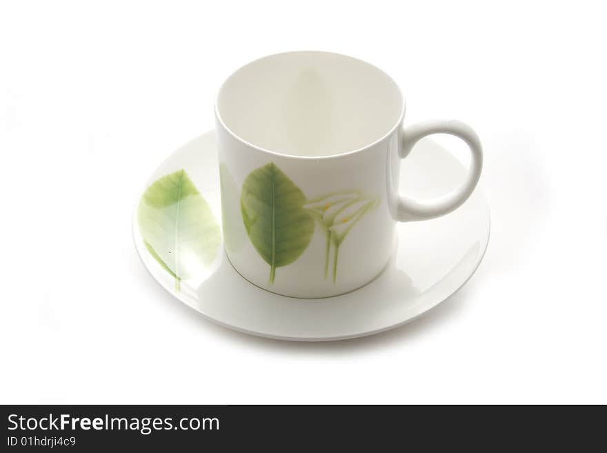 White coffee cup with green leaf