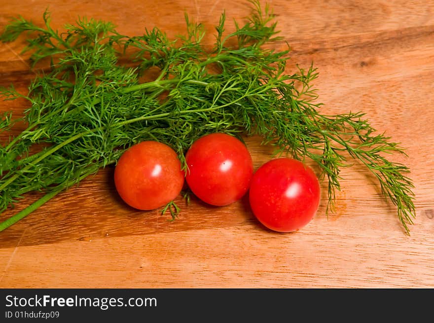 Tomatoes And Dill On A Wooden Background