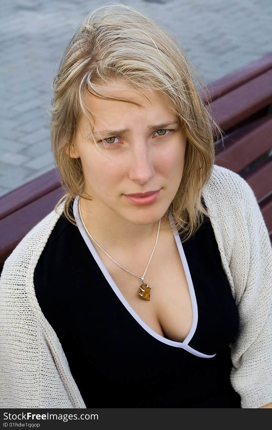 Pretty girl sitting on a bench