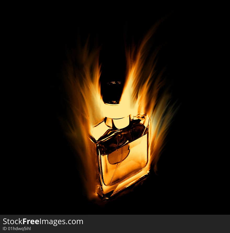 Image of a perfume bottle on fire on a black background. Concept for a very popular perfume. Image of a perfume bottle on fire on a black background. Concept for a very popular perfume.