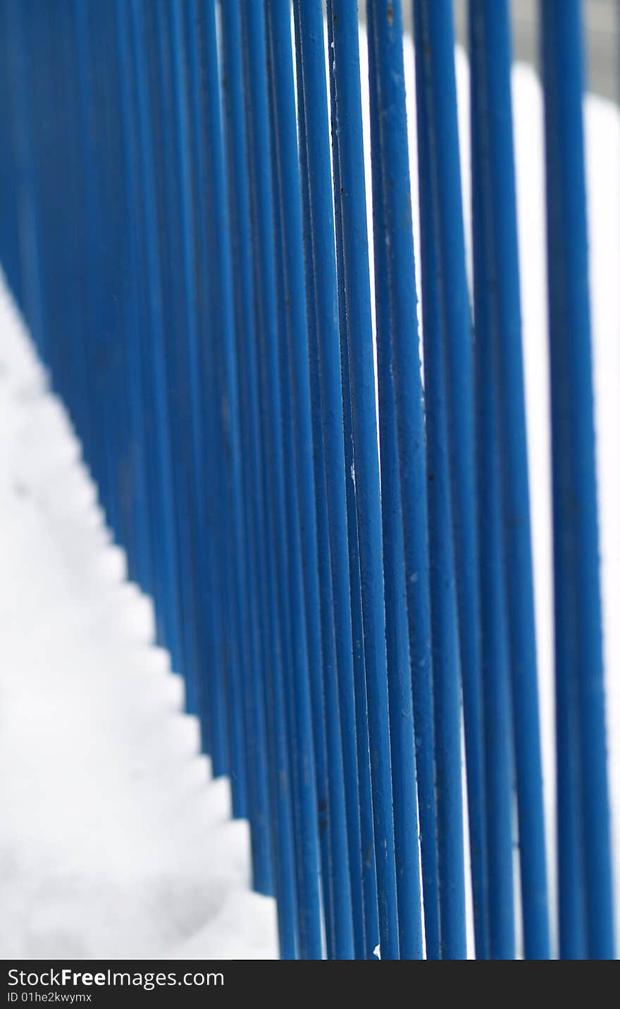 Blue iron railing in snow