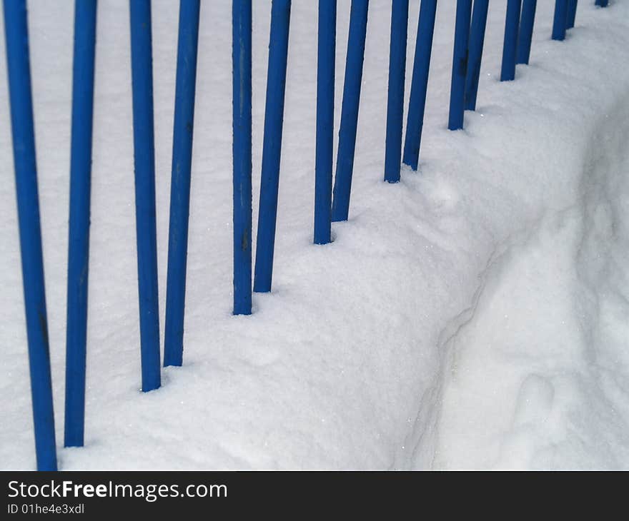 Blue iron railing in snow