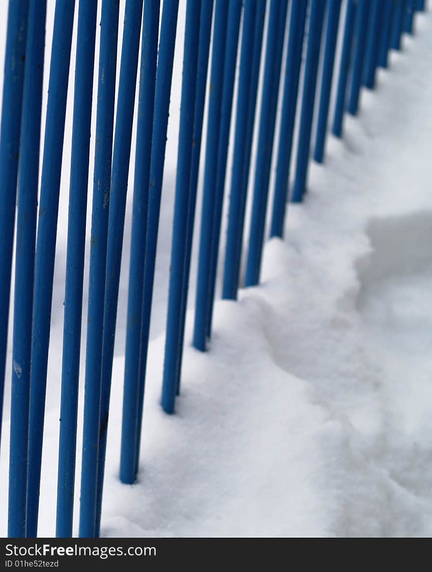 Blue iron railing in snow