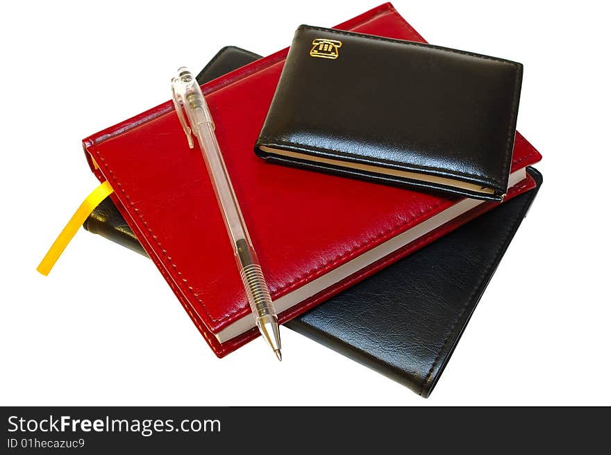 Three notebooks (organizers) and jell pen on isolated background. Three notebooks (organizers) and jell pen on isolated background.