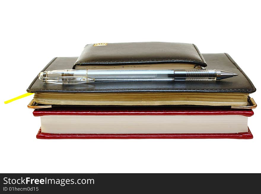 Three notebooks (organizers) and jell pen on isolated background. Three notebooks (organizers) and jell pen on isolated background.