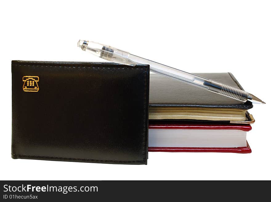 Three notebooks (organizers) and jell pen on isolated background. Three notebooks (organizers) and jell pen on isolated background.