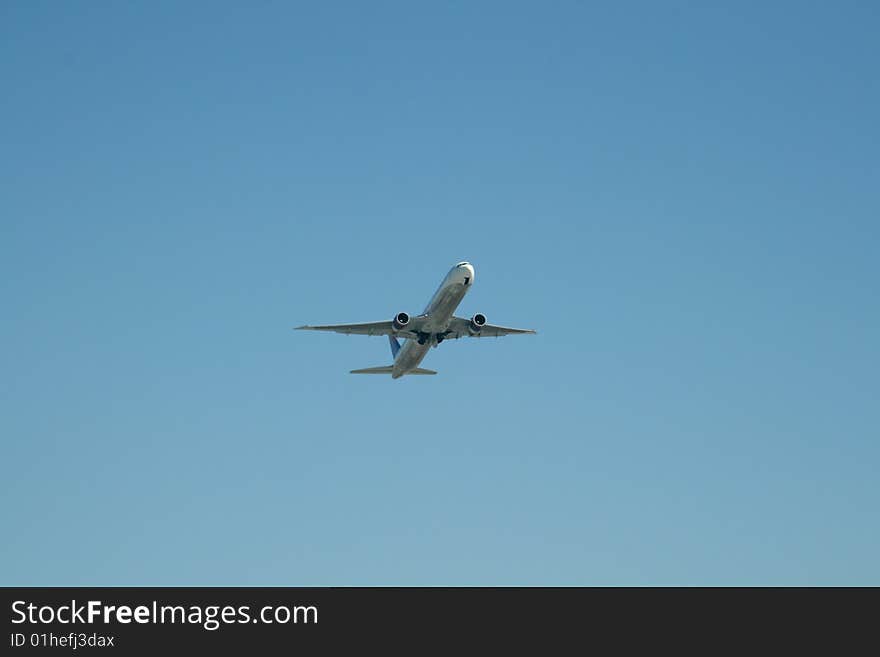 Airliner at takeoff on a clear blue sky