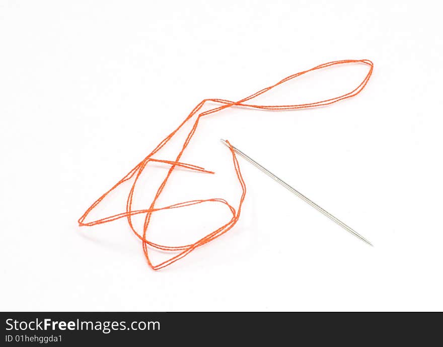 Red string and needle isolated on white background. Red string and needle isolated on white background.