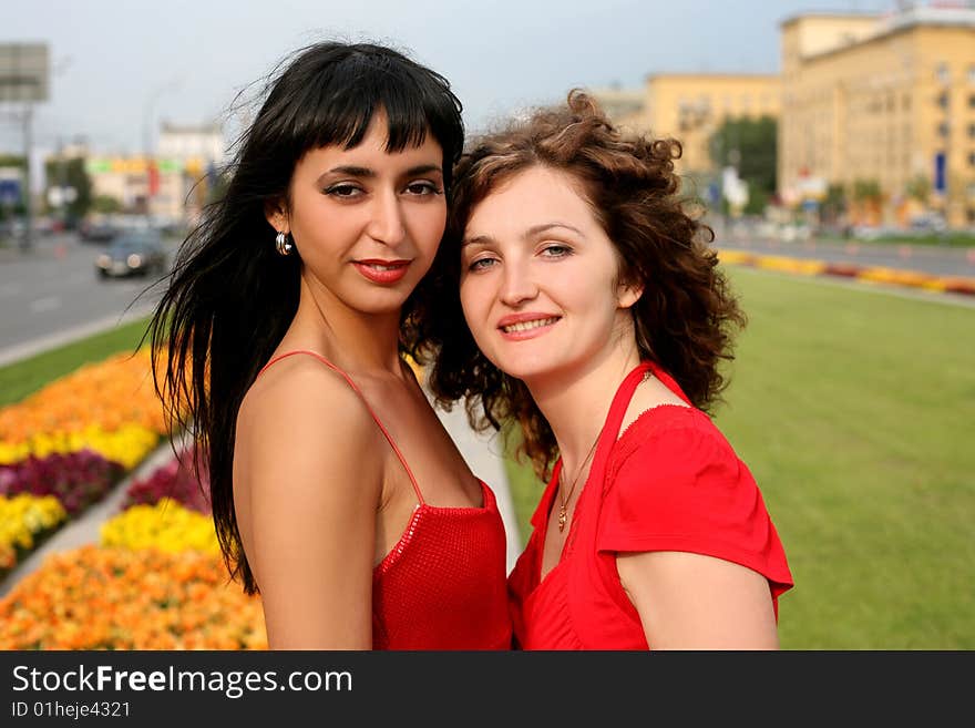 Two girls in city in sunny day. Two girls in city in sunny day