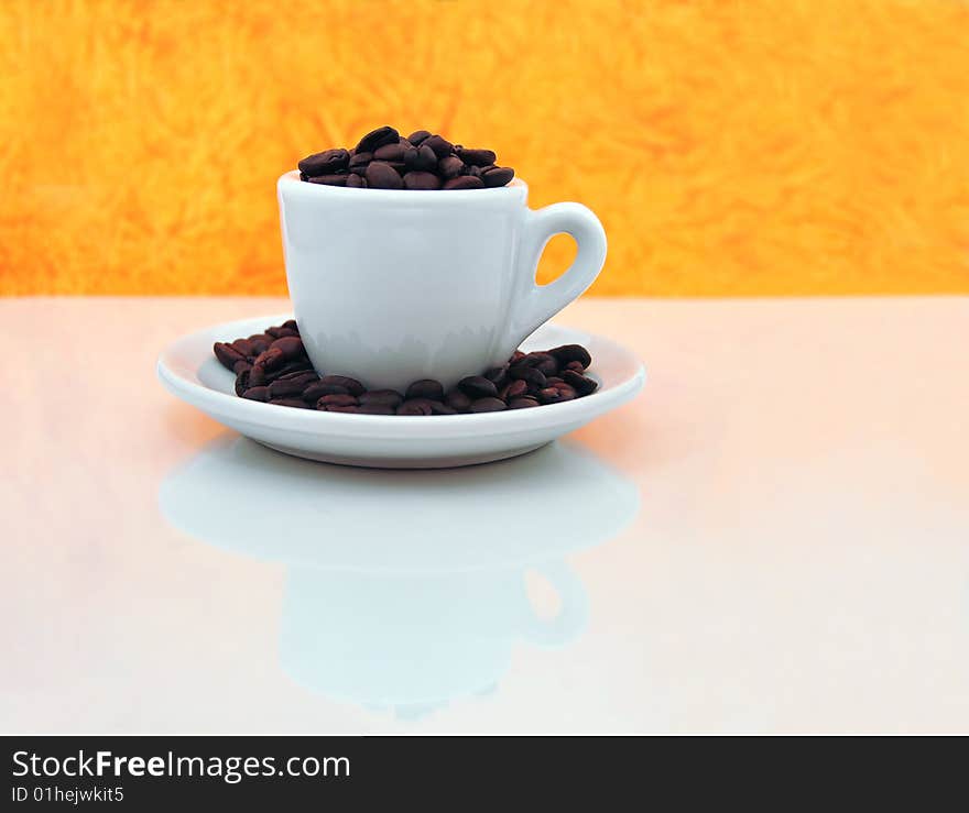 Roasted coffee beans on top of a rugged carpet painted with the Colombian flag colors. Roasted coffee beans on top of a rugged carpet painted with the Colombian flag colors.