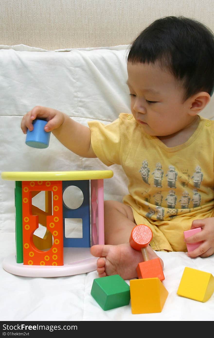 Asia  Child playing colorful blocks. Asia  Child playing colorful blocks.