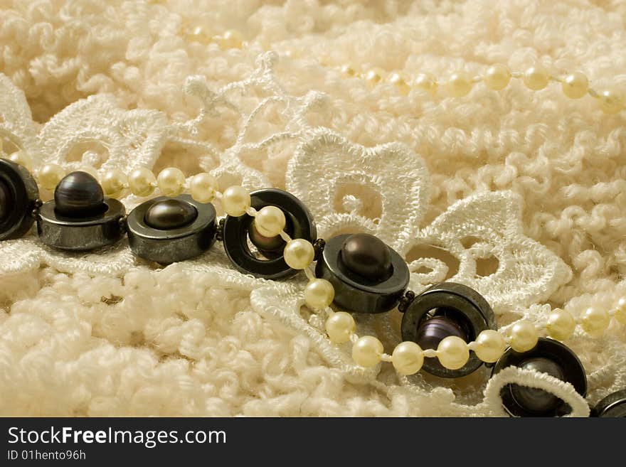 White and black pearls on doll hair wool. White and black pearls on doll hair wool