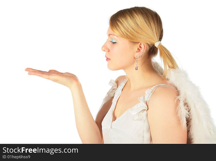 Girl in angel's costume looks on open palm on white background