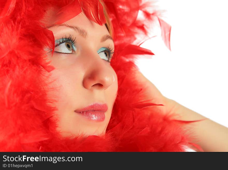 Portrait of girl in red feathers on white background