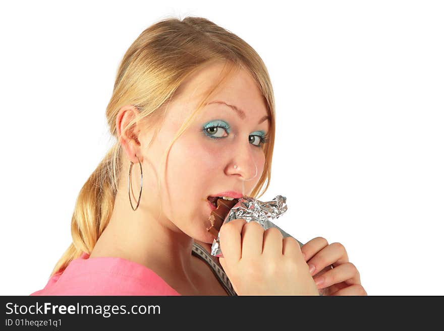 Young girl eats chocolate on white background
