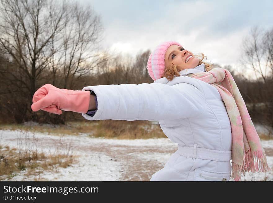 Young girl in winter with stretched hands