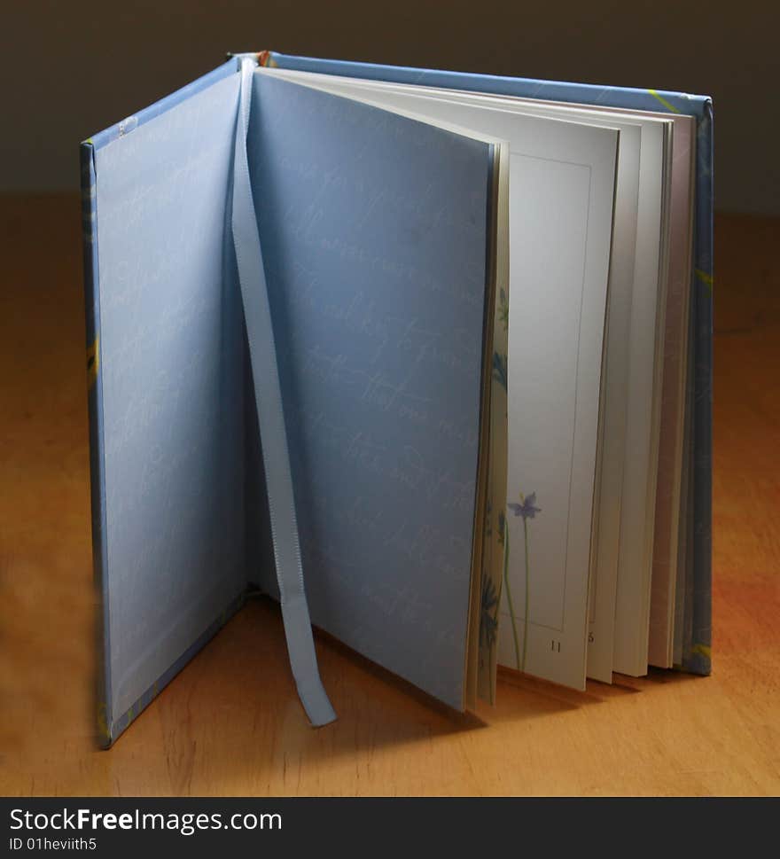 Close up of an open book and blue bookmark. Close up of an open book and blue bookmark