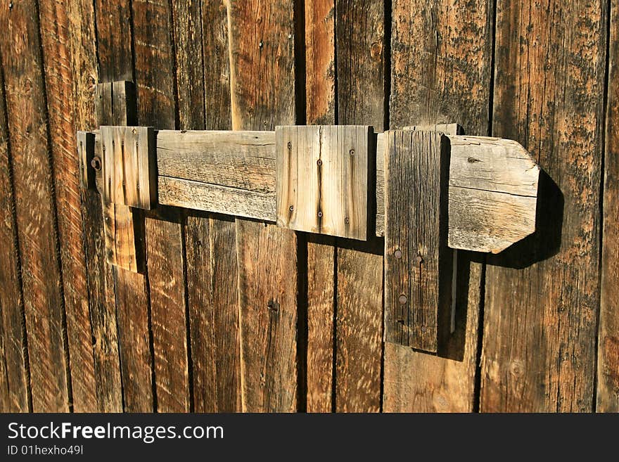 A wooden latch hold back barn doors. A wooden latch hold back barn doors