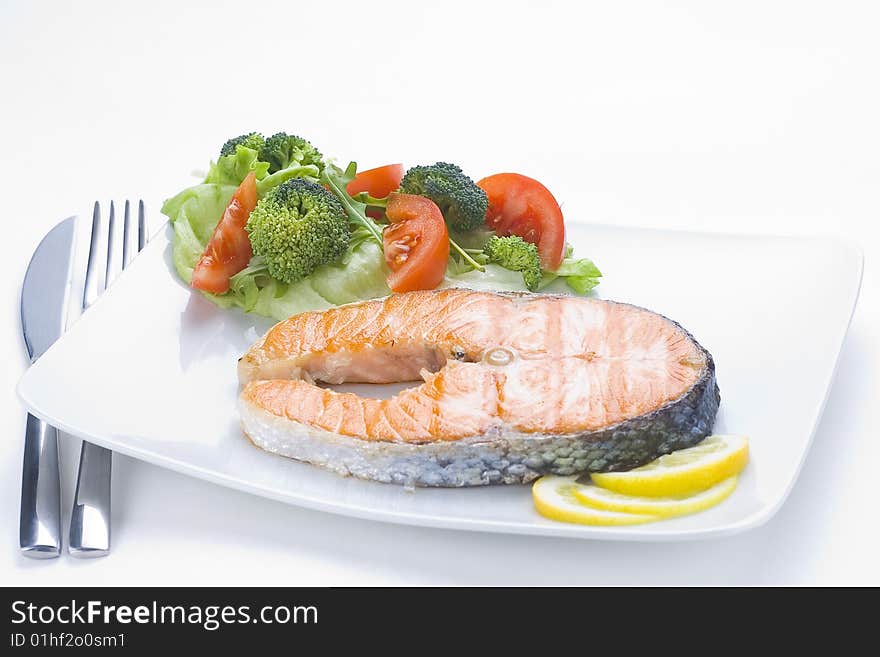 Fresh salmon cooked with tomato salad broccoli salad. Fresh salmon cooked with tomato salad broccoli salad