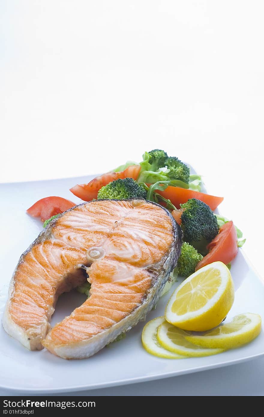 Fresh salmon cooked with salad