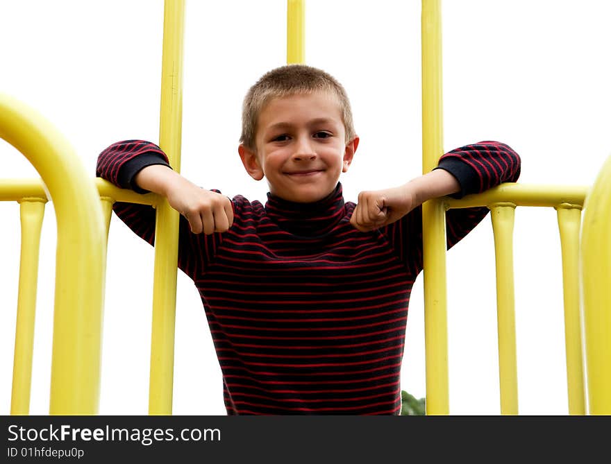 A young boy playing in a public park. A young boy playing in a public park