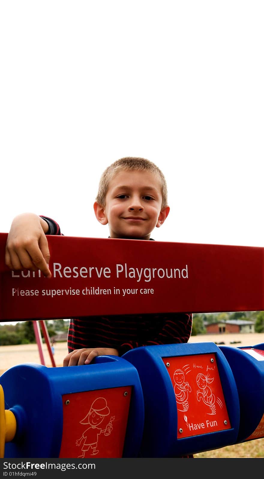 A young boy playing in a public park. A young boy playing in a public park