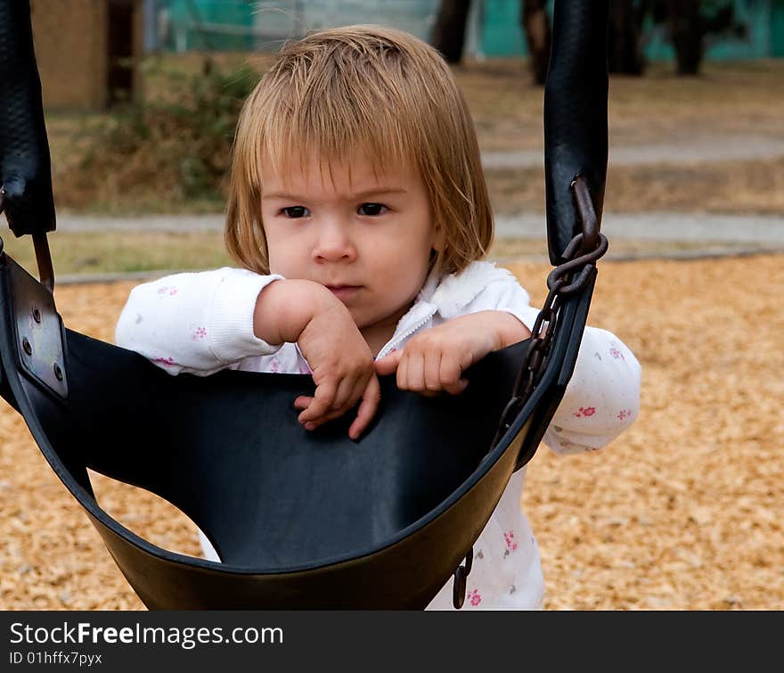 A young girl playing in a public park. A young girl playing in a public park