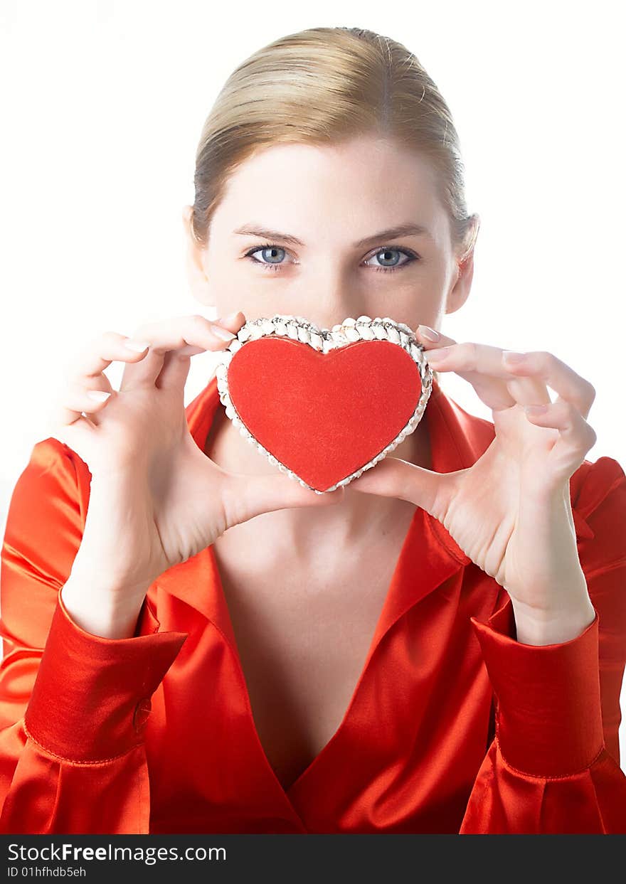 The girl in red holds heart in hands. The girl in red holds heart in hands