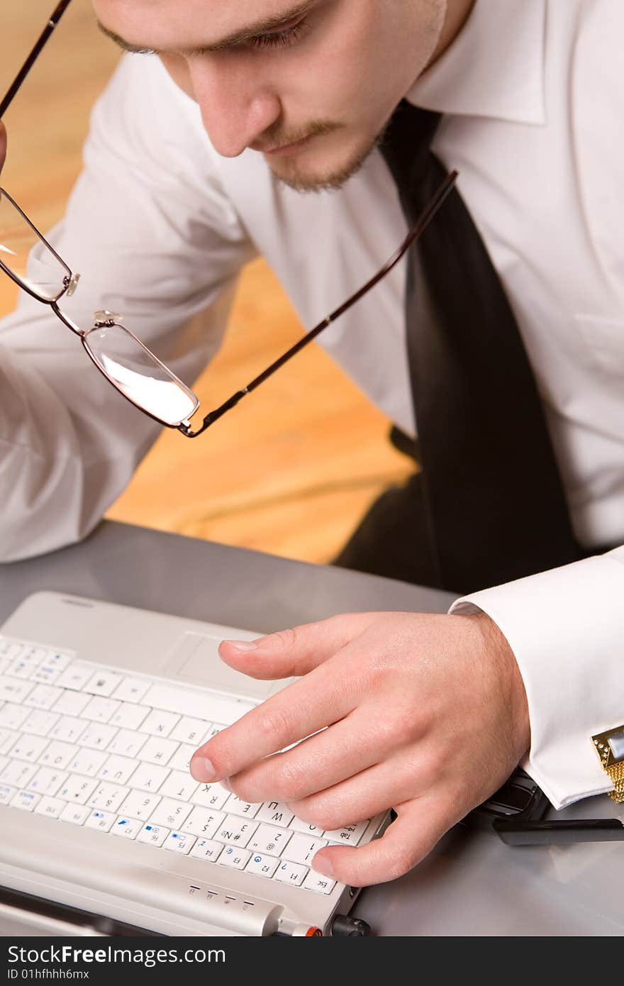 Handsome young businessman working with laptop