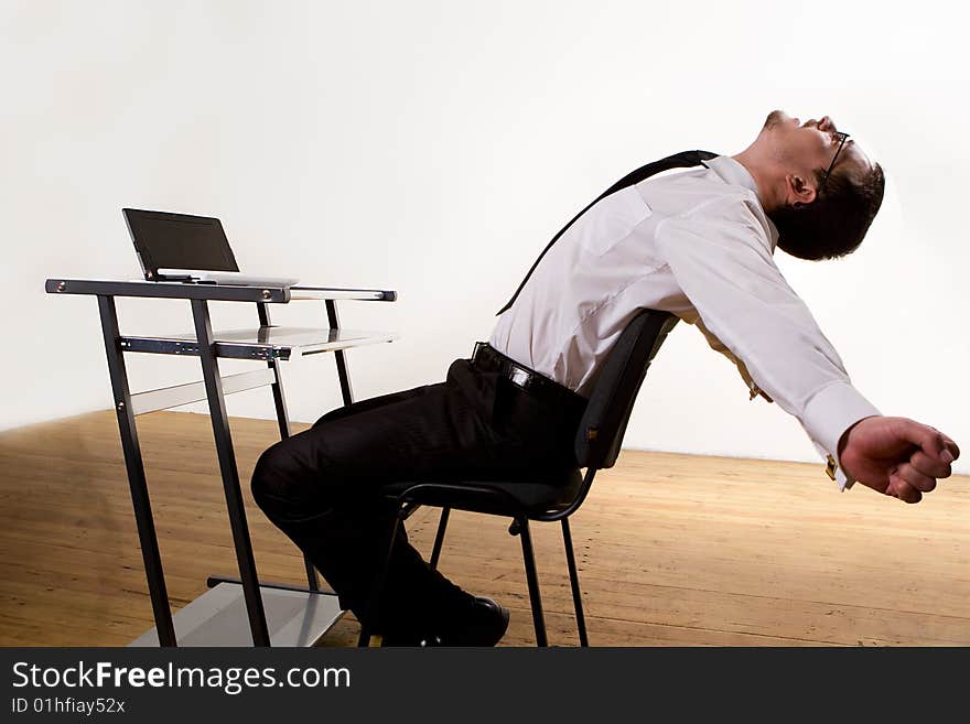 Young hungry businessman eating hamburger