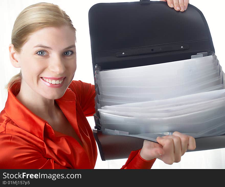 The beautiful girl in red holds in hands a black portfolio