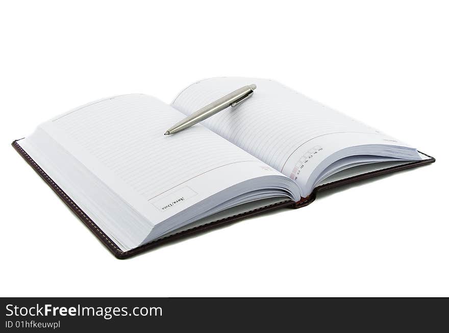 Close up notebook and pen on it isolated over white