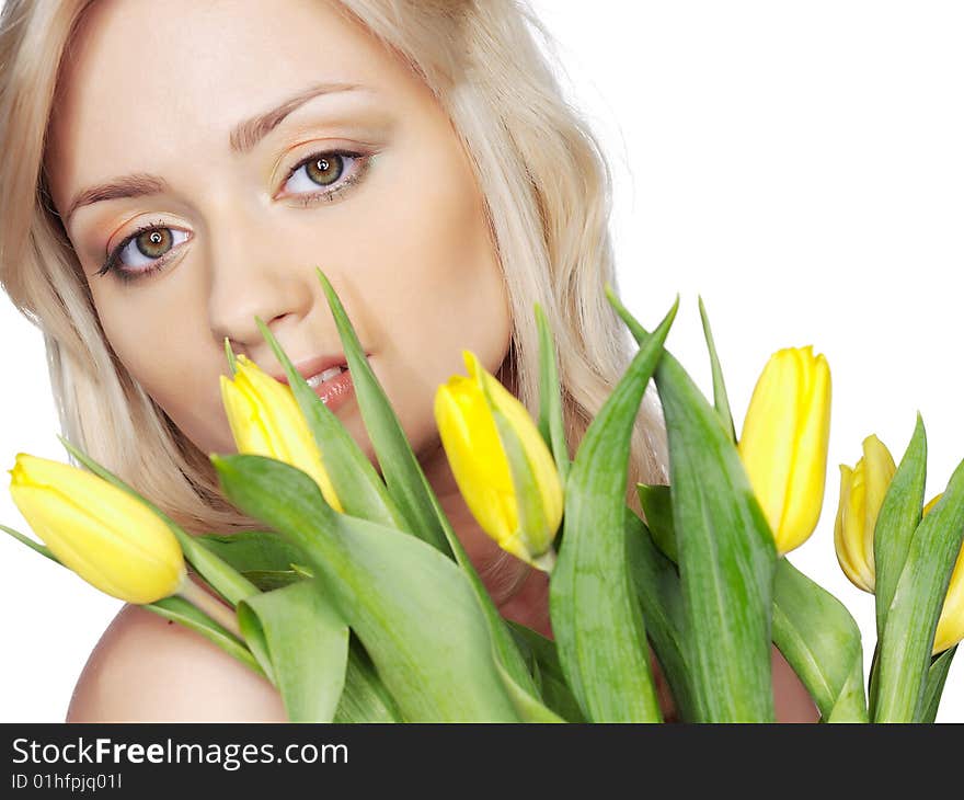 Portrait of the girl on a white background with yellow flowers tulips