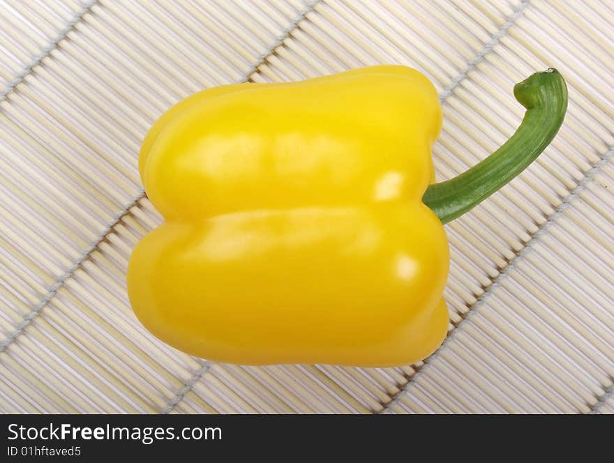 Yellow pepper on mat.