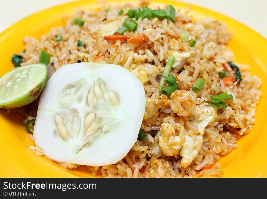 Close up of Indian fried rice on orange plate.