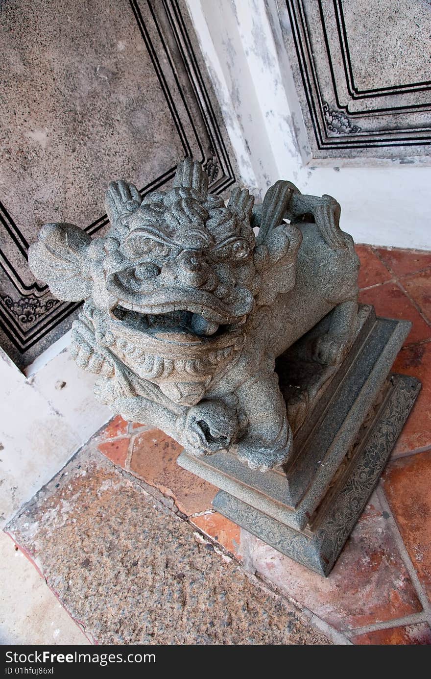 Religious stone lion standing at the entrance