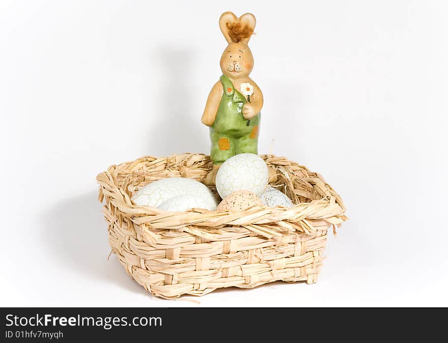 One easter-bunny in the basket with eggs. One easter-bunny in the basket with eggs