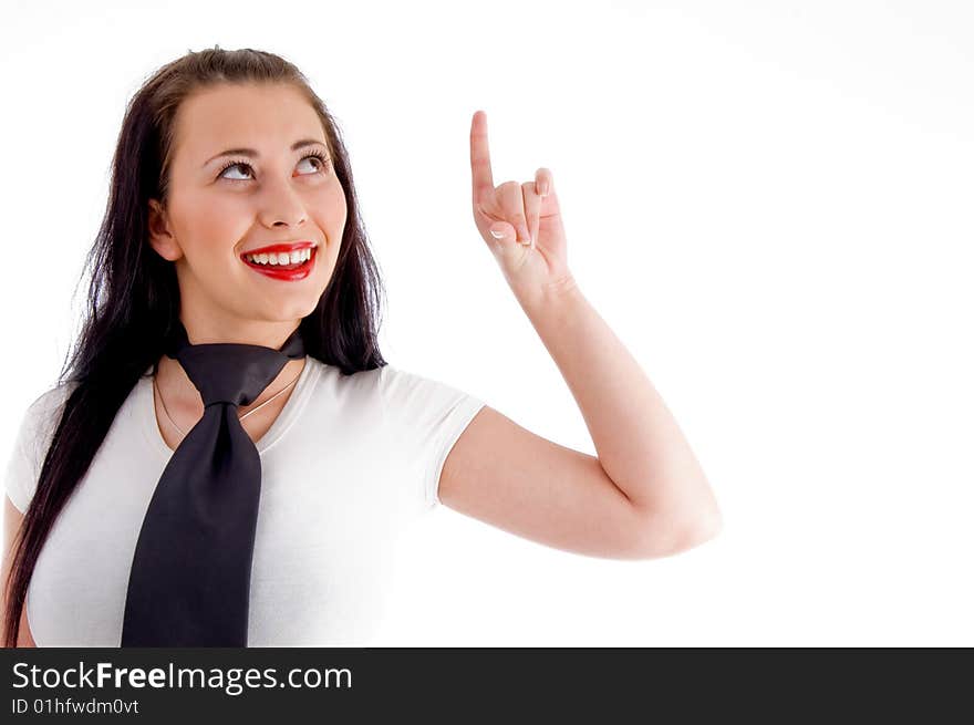 Young woman looking and pointing upwards