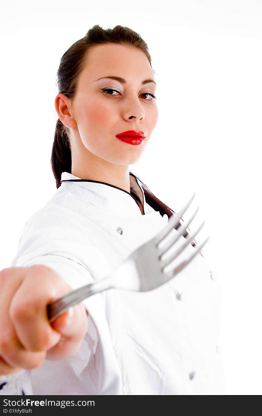 Young female chef showing fork with white background