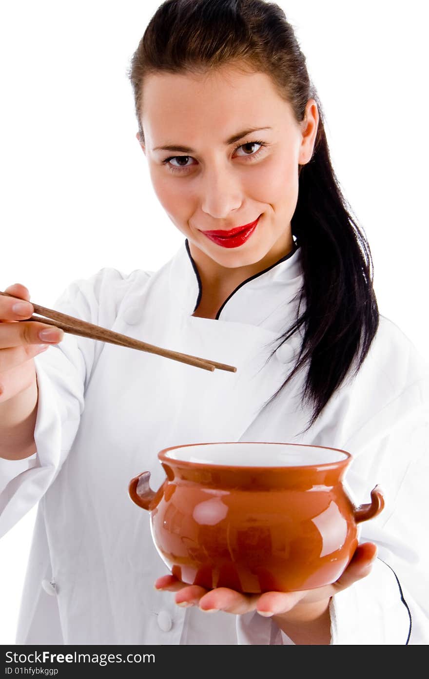 Woman chef with chopsticks and porcelain pot on an isolated white background