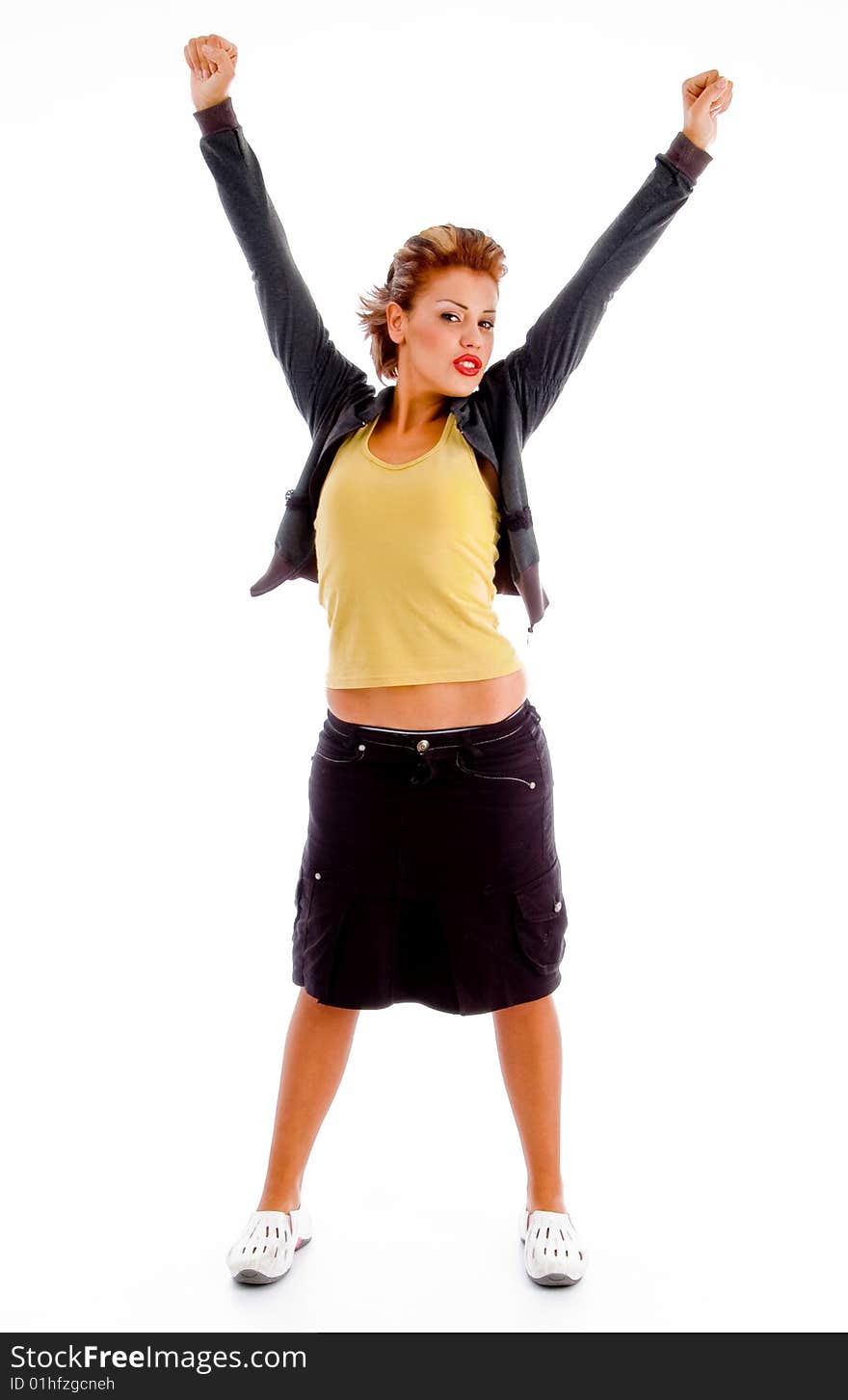 Standing sexy woman showing winning gesture on an isolated background