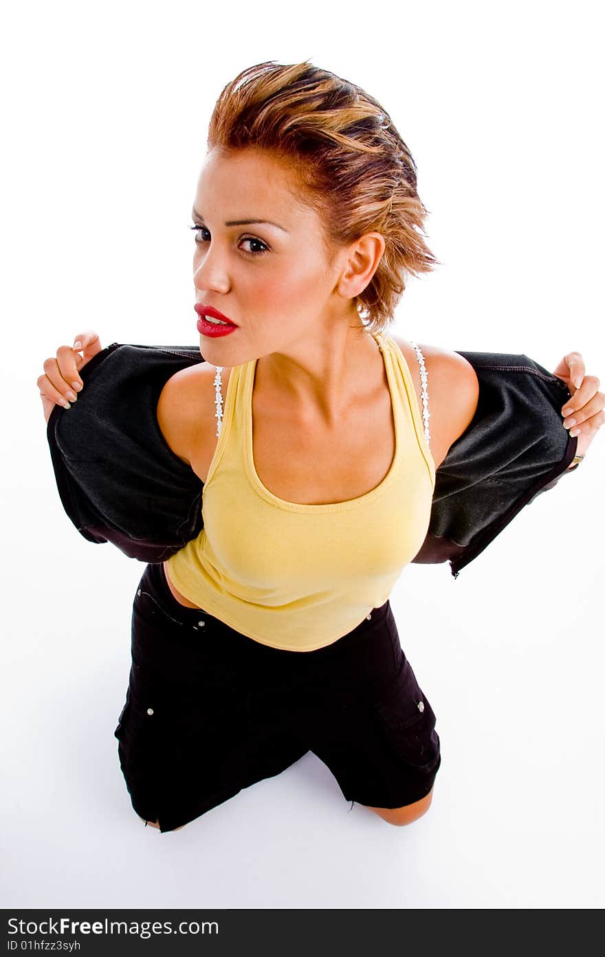 Sitting woman putting off her jacket on an isolated background