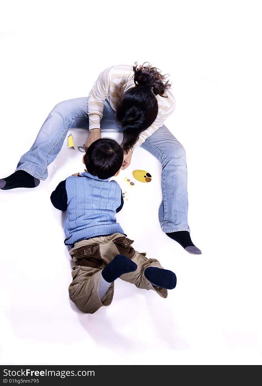 a picture of a little chinese boy playing games with his mother and having great fun. a picture of a little chinese boy playing games with his mother and having great fun