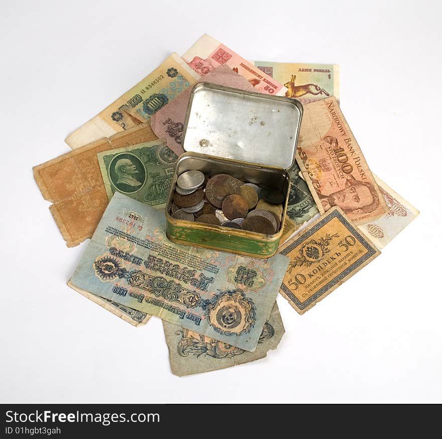 Old currency and metal box with old coins isolate