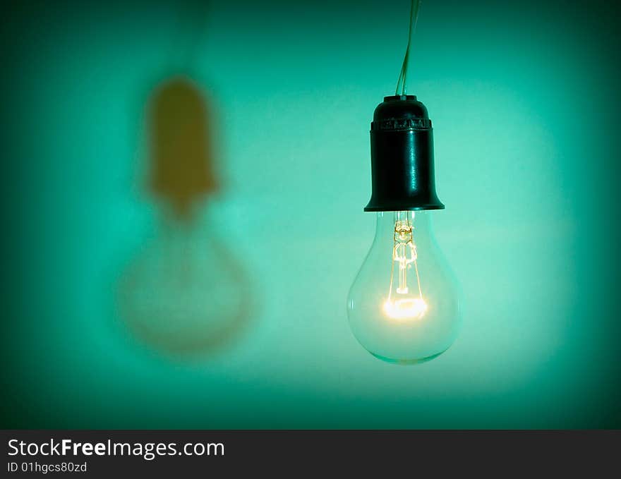 Light bulb on green background