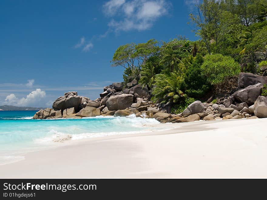 Seychelles stones and palm trees on the bank of azure ocean. Seychelles stones and palm trees on the bank of azure ocean